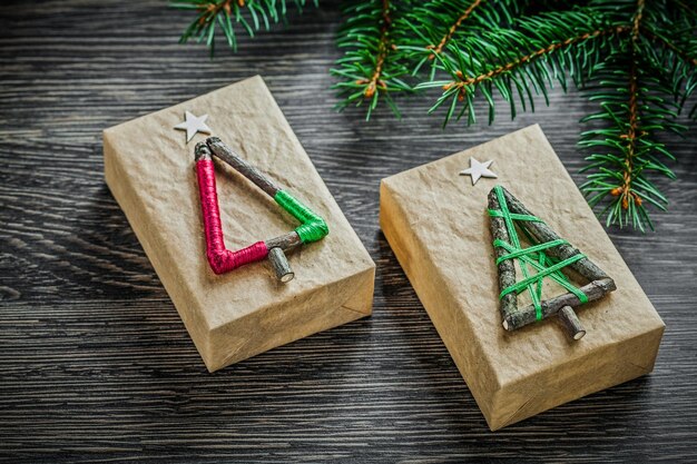 Fir branch wrapped present box on wooden board