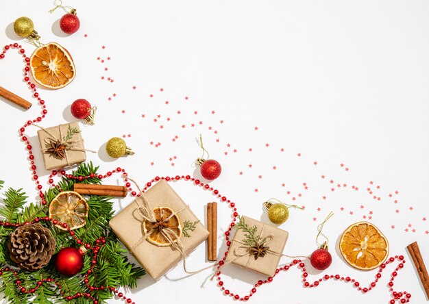 Fir branches, gift boxes, Christmas balls on white 