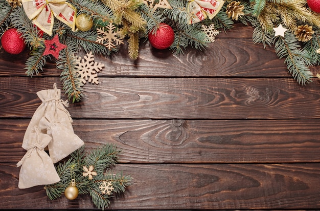 Fir branches with Christmas decor on old dark wooden