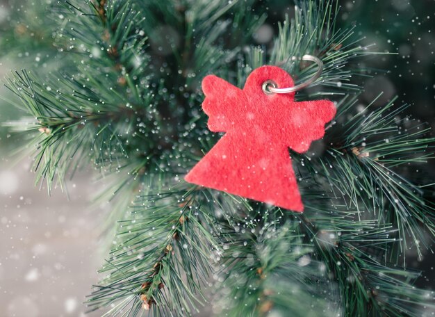 Fir branches with red angel keychain