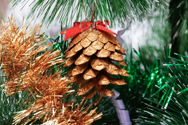 A fir cone on a smart christmas tree closeup