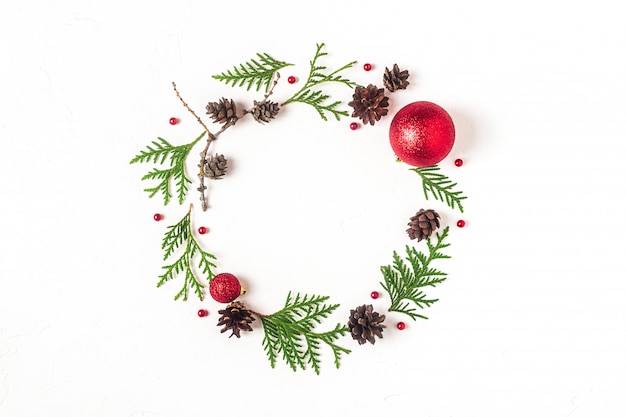 Fir leaves and pine cones with ornaments