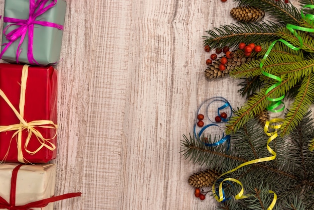 Fir tree branches with cones on wooden table. Christmas and New Year postcard