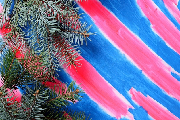 Fir tree branchs on a pinkblue background View from above Closeup Blank space for signature