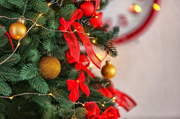 Fir tree with Christmas decorations in room, close up