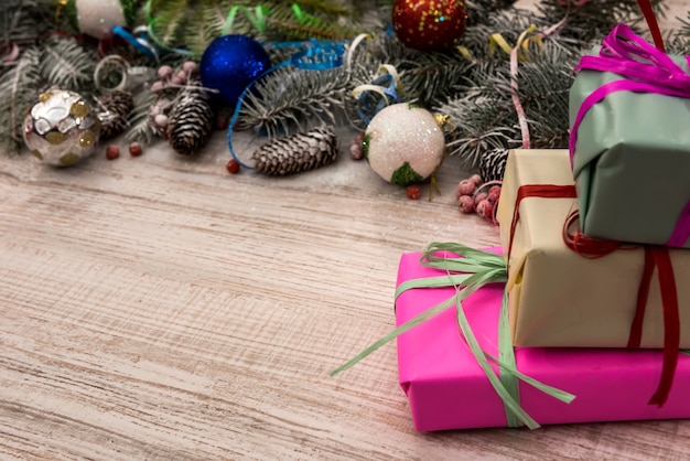 Fir tree with gift boxes on wooden table. Christmas presents concept, postcard, greeting