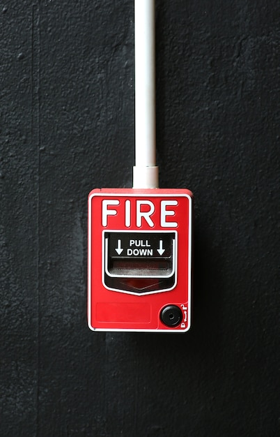 Photo fire alarm on black wall