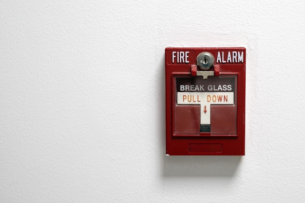 Fire alarm box on a white wall with copu space