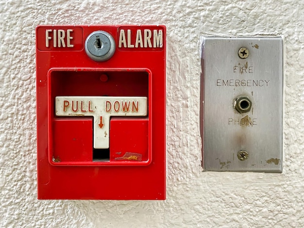Photo fire alarm switch on cement wall for warning and security system