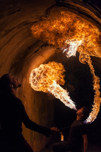 Fire artist blowing fire from his mouth