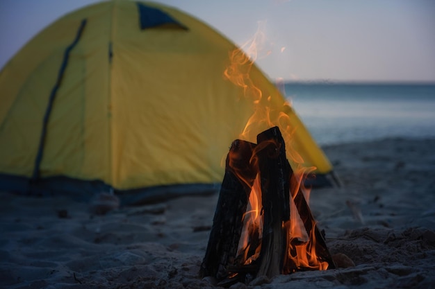 Fire in bonfire in the beach Camping and tents to travel