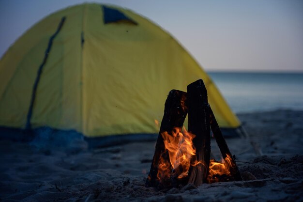 Fire in bonfire in the beach Camping and tents to travel