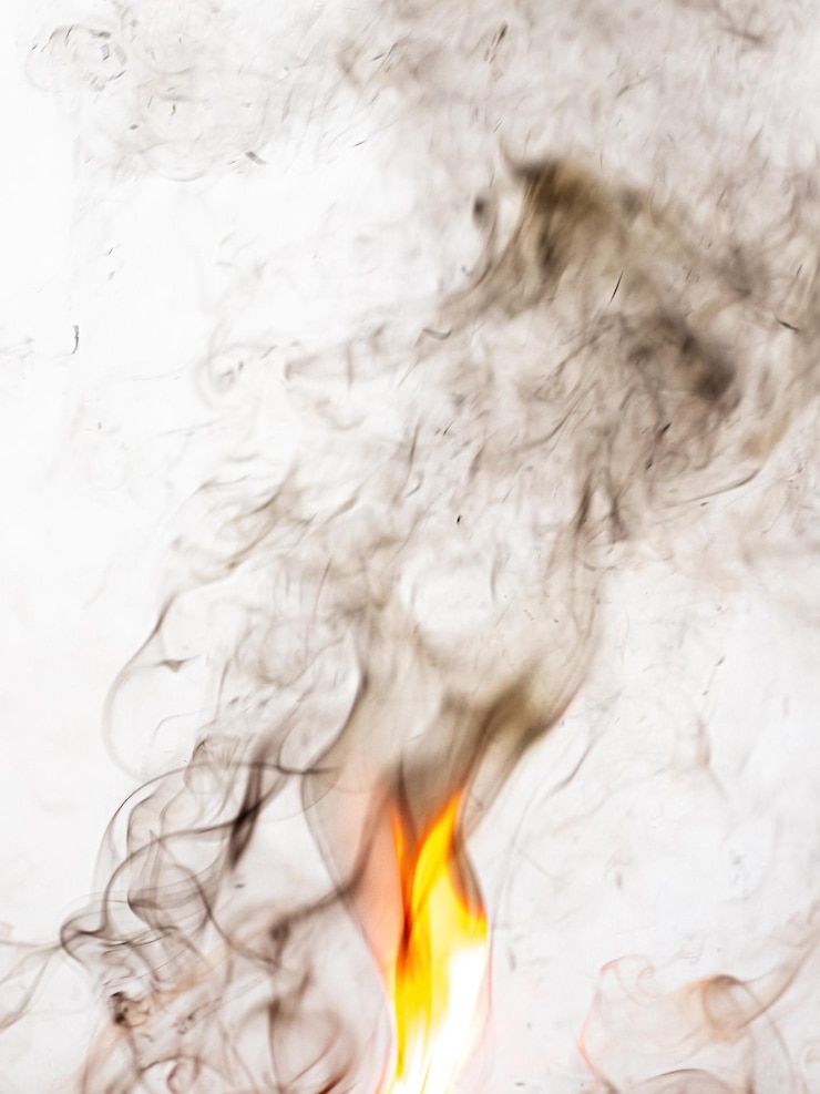 Photo fire and brown smoke on a light background