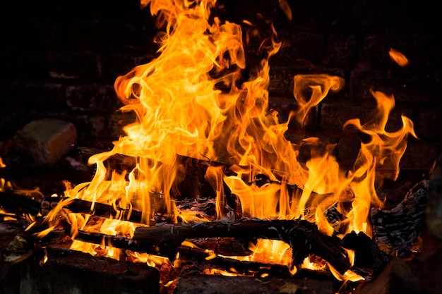 Fire burning in a brick fireplace. Red and yellow flames.