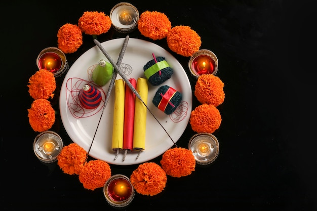 Fire crackers,lamp and flower on dark background , Indian festival Diwali