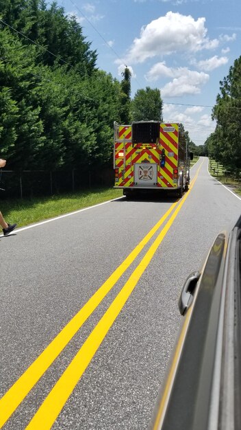 Fire engine on road on sunny day