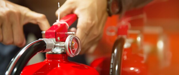 Fire engineering checking handle of fire extinguisher.