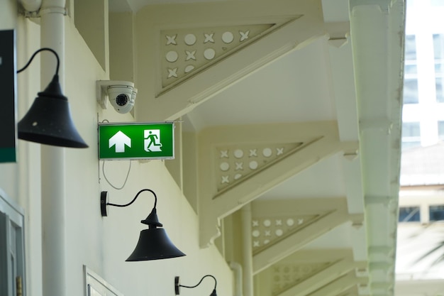 Fire exit signs with CCTV outside the building