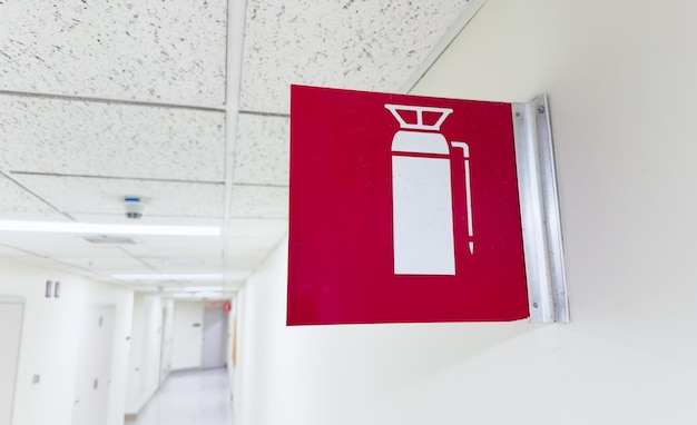 fire extinguisher against a white wall symbolizing safety and preparedness in case of emergency wi