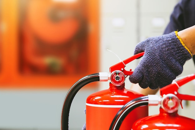 Photo fire extinguisher has hand engineer checking