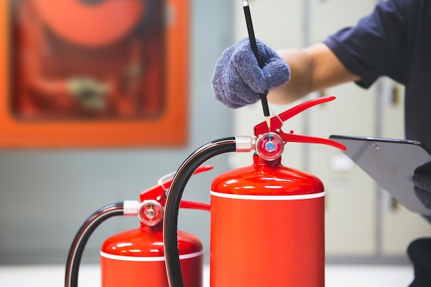 Photo fire extinguisher has hand engineer checking