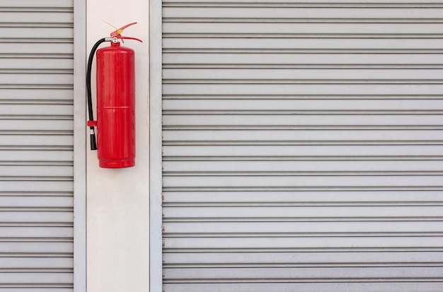 Photo fire extinguisher on the shutter door at home