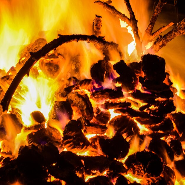 Fire flames on black background blaze fire flame texture background beautifully the fire is burning fire flames with wood and cow dung bonfire