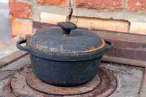 Photo fire hearth of russian oven and old cast iron pot