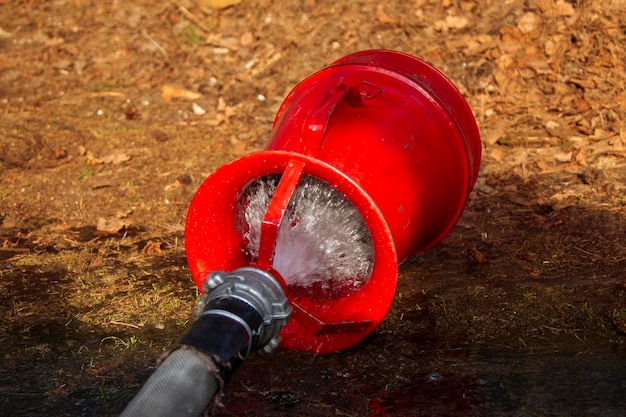 Fire hose with water on the ground Fire extinguishing