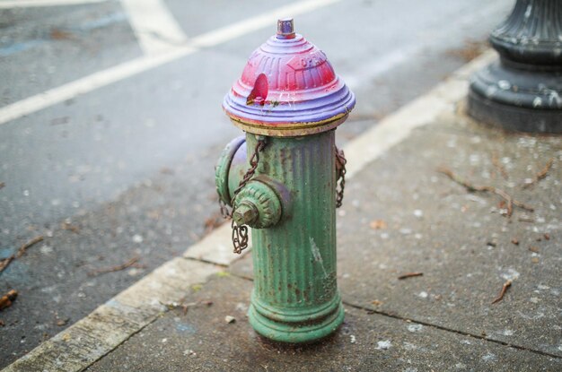 A fire hydrant that is painted in rainbow colors.