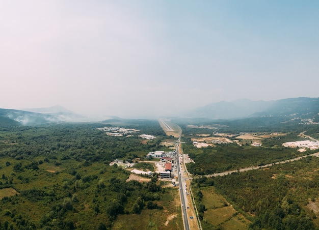 Fire on the lustica peninsula mountains covered with white smoke the drone flies over the budvativat