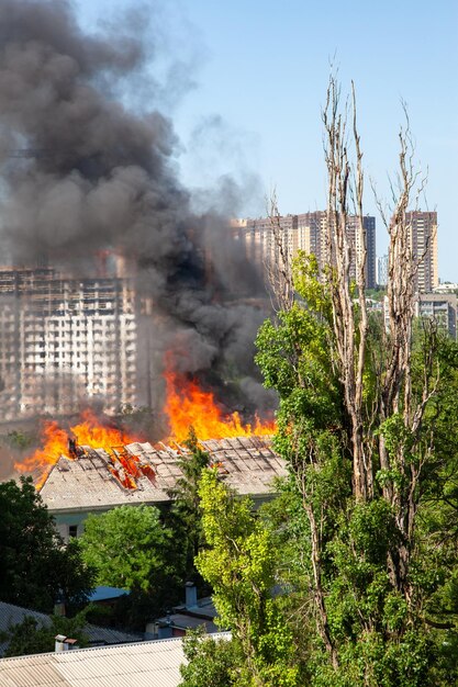 A fire in an old abandoned house a view from the window of a neighboring highrise building