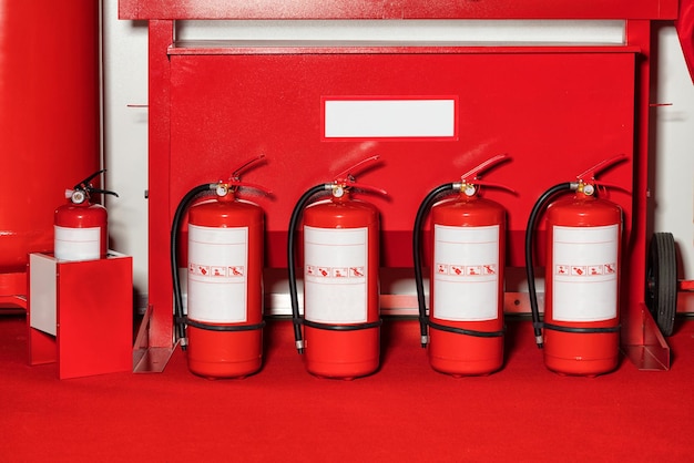 Fire shield with fire extinguishers standing in a row