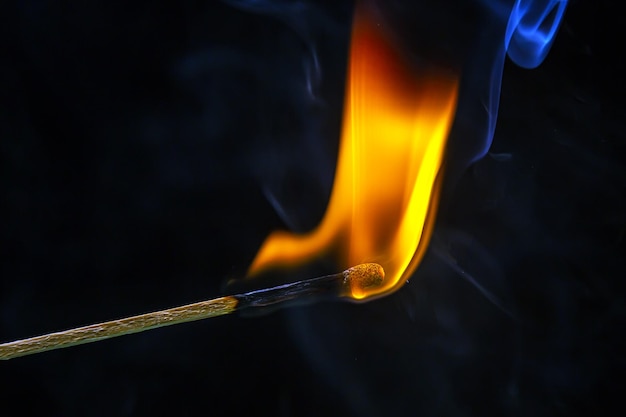 Fire and smoke Burning and smoking match on a black background Heat and light from fire flame