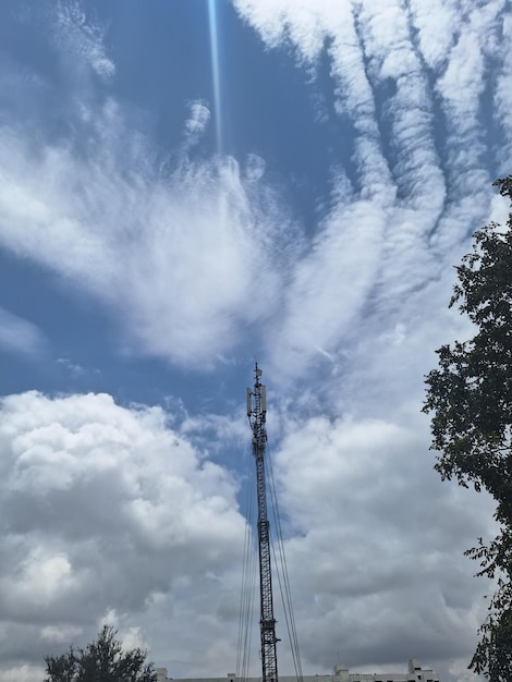 A fire tower in the sky with smoke coming out of it