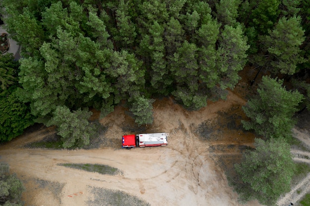 Fire truck in the forest top view from a drone