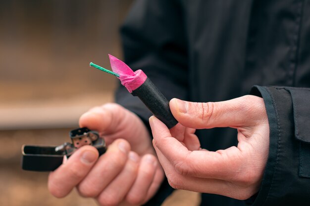 Photo firecracker and lighter in a hand