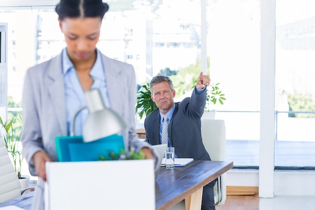 A fired businesswoman holding box 