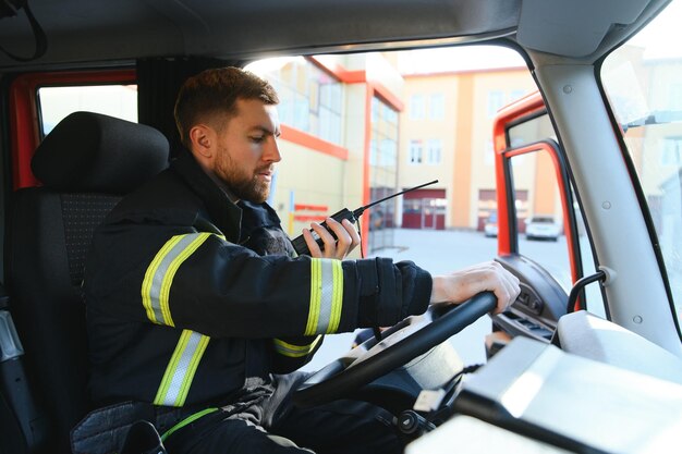 Photo firefighter drives a emergency vehicle with communication interior view