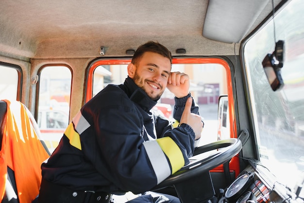 Firefighter at the wheel of an emergency vehicle drives to the scene of action and extinguishes fire