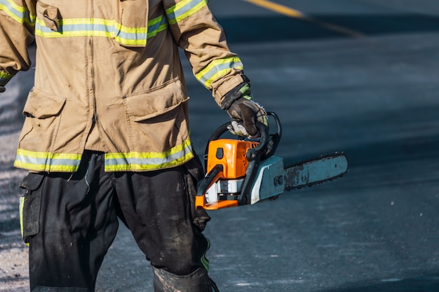 Firefighter with chainsaw in rescue.