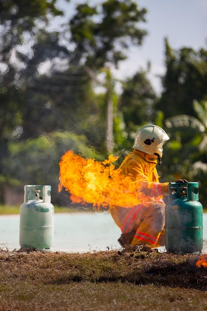 Firefighter with fire and suit for protect fire fighter for training firefighters