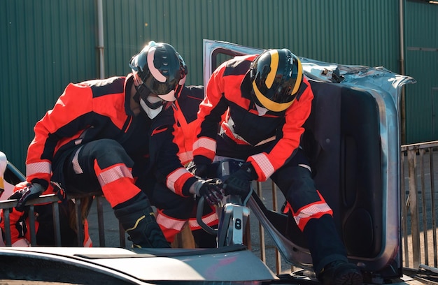 Firefighters rescuing a victim in a car accident