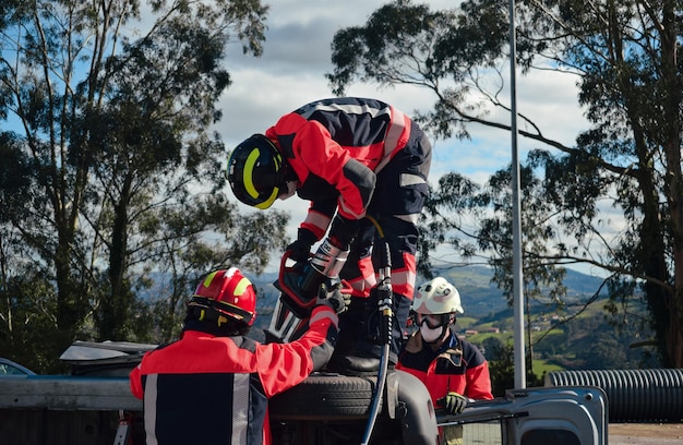 Firefighters rescuing a victim from a car during an accident