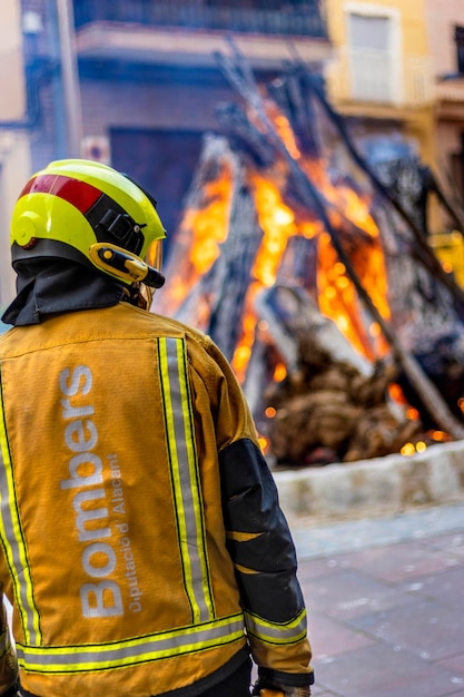 Fireman equipped to act with a fire in the background