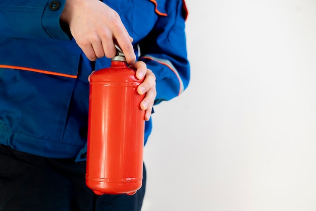 Fireman man holding a fire extinguisher, safe work and precautions concept