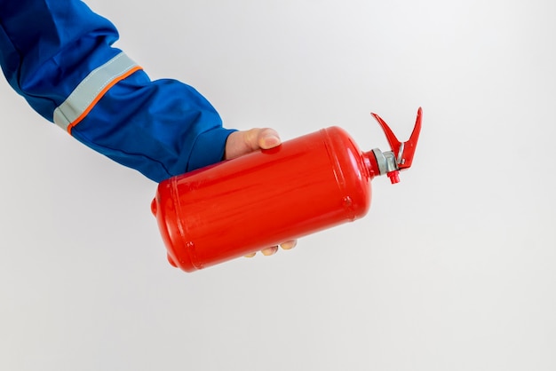 Fireman man holding a fire extinguisher, safe work and precautions concept