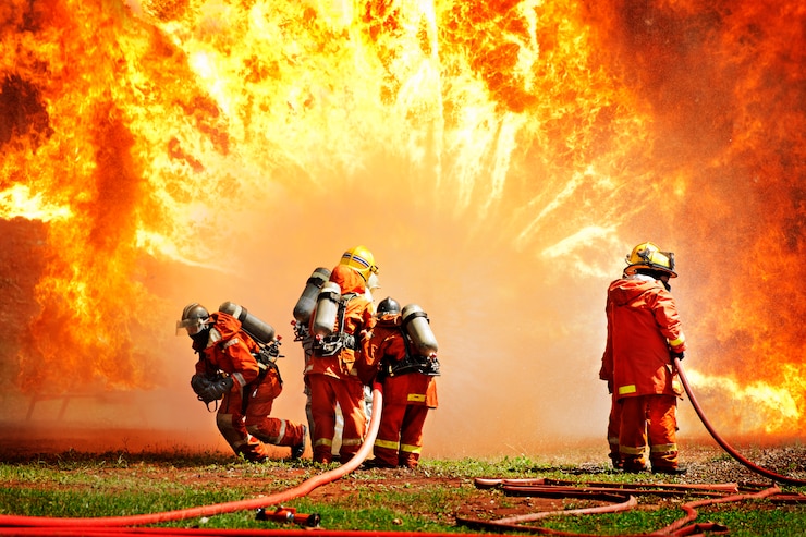 Photo firemen using extinguisher and water for fighter fire during firefight training. 