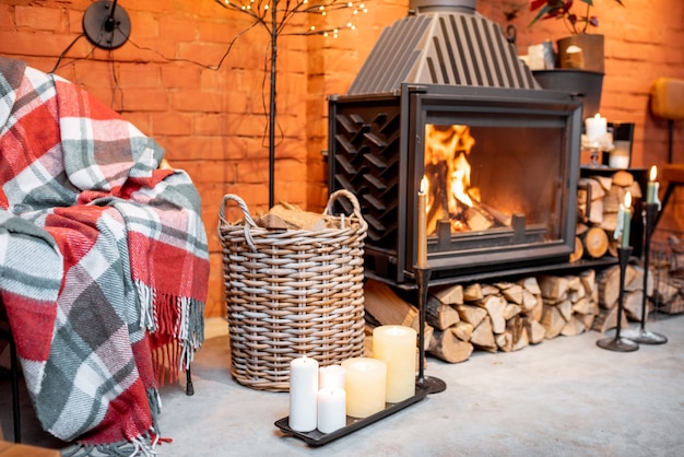 Fireplace area of a beautiful loft-style interior decorated for the New Year holidays. The concept of home comfort