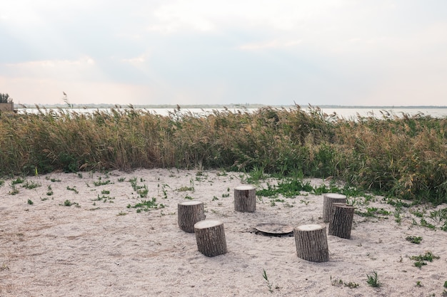 Fireplace in the nature, sea view. preparing for a summer\
party. sitting by the fire. camp fire